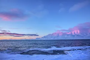 Sunrays: Adventfjorden sunset - last sunrays casting pink light on mo