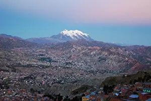 Population: Aerial of La Paz and Mount Illimani at dusk with pink light