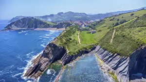 Waves: Aerial perspective captures the stunning beauty of zumaia's flysch cliffs meeting the vibrant blue ocean on a