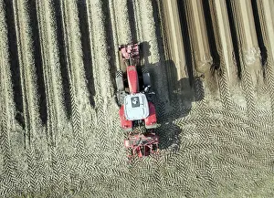 Working: An aerial photo shows a tractor in a large asparagus