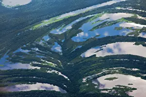 Lowlands: Aerial of river and tree savannah reflection clouds