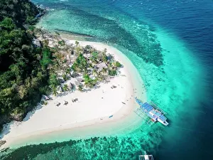 Dreamlike: Aerial view, boat at tropical palm island with sandy