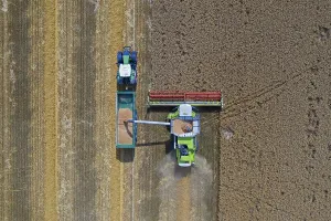 Trailer: Aerial view of combine harvester and tractor with