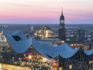 Church: Aerial view of the Elbphilarmonie with St Michael's Church and Hamburg Bunker in the background at blue hour