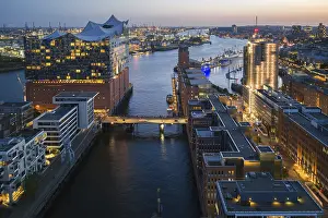 Port: Aerial view of the Elbphilharmonie at blue hour with harbour and Elbe in the background