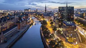Canals: Aerial view of Hamburg's Speicherstadt warehouse district at blue hour with a view of the Zollkanal