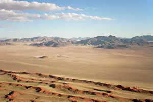 Ridges: Aerial view of sand dunes and isolated mountain