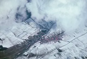 Janis: Aerial view of a snow-dusted rural village