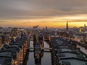 Port: Aerial view of the Speicherstadt Hamburg with evening lighting and view over the harbour with Elbphilharmonie