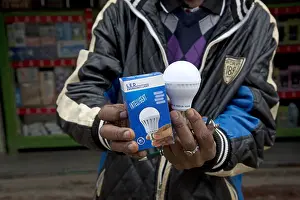 Mark Boulton: African man holding intelligent energy effiicient
