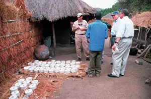 Inspecting: Aid advisors inspecting fuel brickette making project
