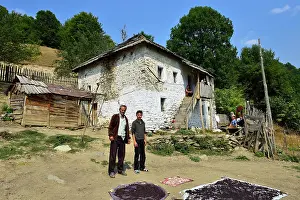 Farmers: Albanian family in front of their old farmhouse