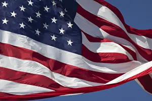 Waving: American flag waving in the wind against deep blue sky