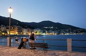 Bench: Angler on pier at dusk, Alassio, Liguria, Riviera