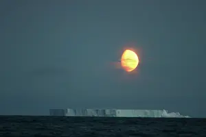 Strait: Antarctica, Gibbous moon rises above massive