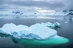 Iceberg: Antarctica. Icebergs and mountains at sunset. ic Cathy &
