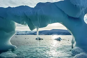 Arched: Antarctica, Icicles hang from arched iceberg