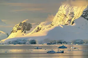 Iceberg: Antarctica, Paradise Bay. Mountain reflections at sunset