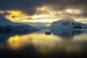 Iceberg: Antarctica, Paradise Bay. Mountain reflections at sunset