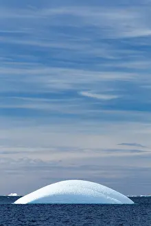 Gerlache: Antarctica, Sunshine lights rounded iceberg
