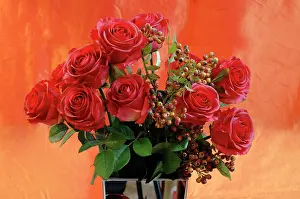Shops: Artificial red silk roses in a vase in front of