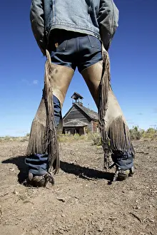 Backview: Backview of cowboy by old 1900's school building