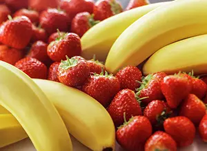 Strawberries: Banana, Musa acuminata, Two bunches with strawberries