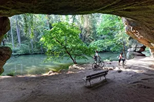 Bicycle: Bank and cyclist in front of Gutav Adolf cave, geotope