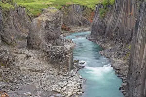 Columns: Basalt rock formations at canyon Studlagil - Austurland