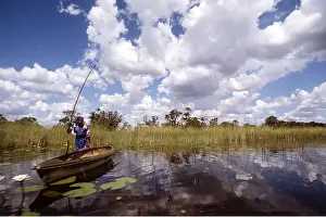 Chris Harvey: BaYei woman with Makoro canoe
