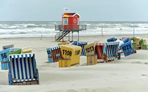 Seashore: Empty beach chairs on a windy day on the beach o