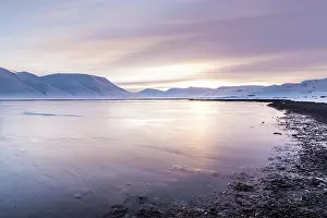 Longyearbyen: Beach with snow capped mountains in the background