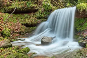 Loneliness: Beautiful fresh mountain waterfall in a wild and