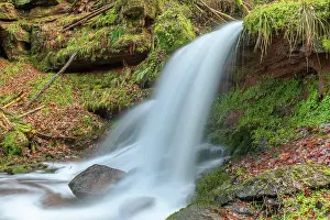 Loneliness: Beautiful fresh mountain waterfall in a wild and