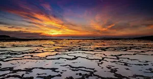 Alentejo: A beautiful sunset over the ocean with rocky beach