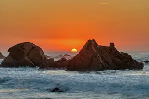 Surf: Beautiful sunset on a rocky beach on the Atlanti