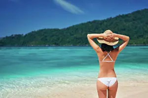 Paradise: Beautiful young woman in white bikini and straw