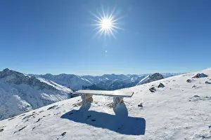 Bench: Bench on Karwendel mountainrange with sun in winter