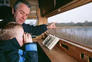 Binoculars: BIRD WATCHING - adult & boy watching from hide