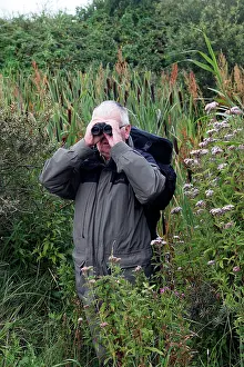Binoculars: Birdwatcher - with binoculars in 'Parc ornithologique