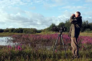 Binoculars: Birdwatcher - with camera & binoculars in 'Parc