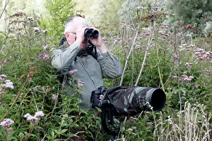 Binoculars: Birdwatcher - with camera & binoculars in 'Parc