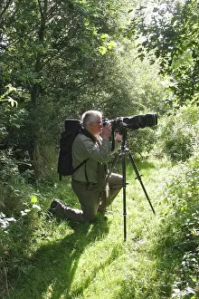 Binoculars: Birdwatcher - with camera in 'Parc ornithologique