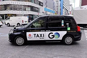 Driving: Black Japanese taxi driving through Ginza, Tokyo, Japan