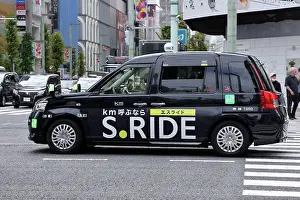 Driving: Black Japanese taxi driving through Ginza, Tokyo, Japan