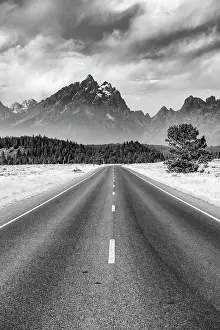 Monochrome: Black and white, country road in front of rugged