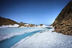 Glaciers: Blue glacial lake surrounded by snow and ice