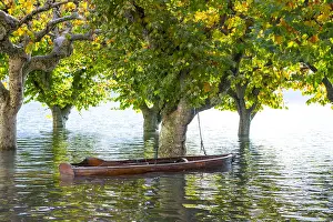 Flooding: Boat on a flooding alpine lake Lago Maggiore with