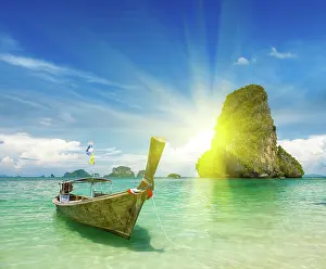 Moored: Boat moored in shallows with sun behind