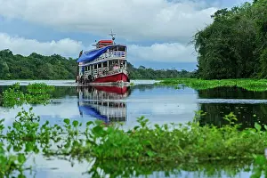 Mamiraua: boat on Solimoes River, flooded forest, Amazon